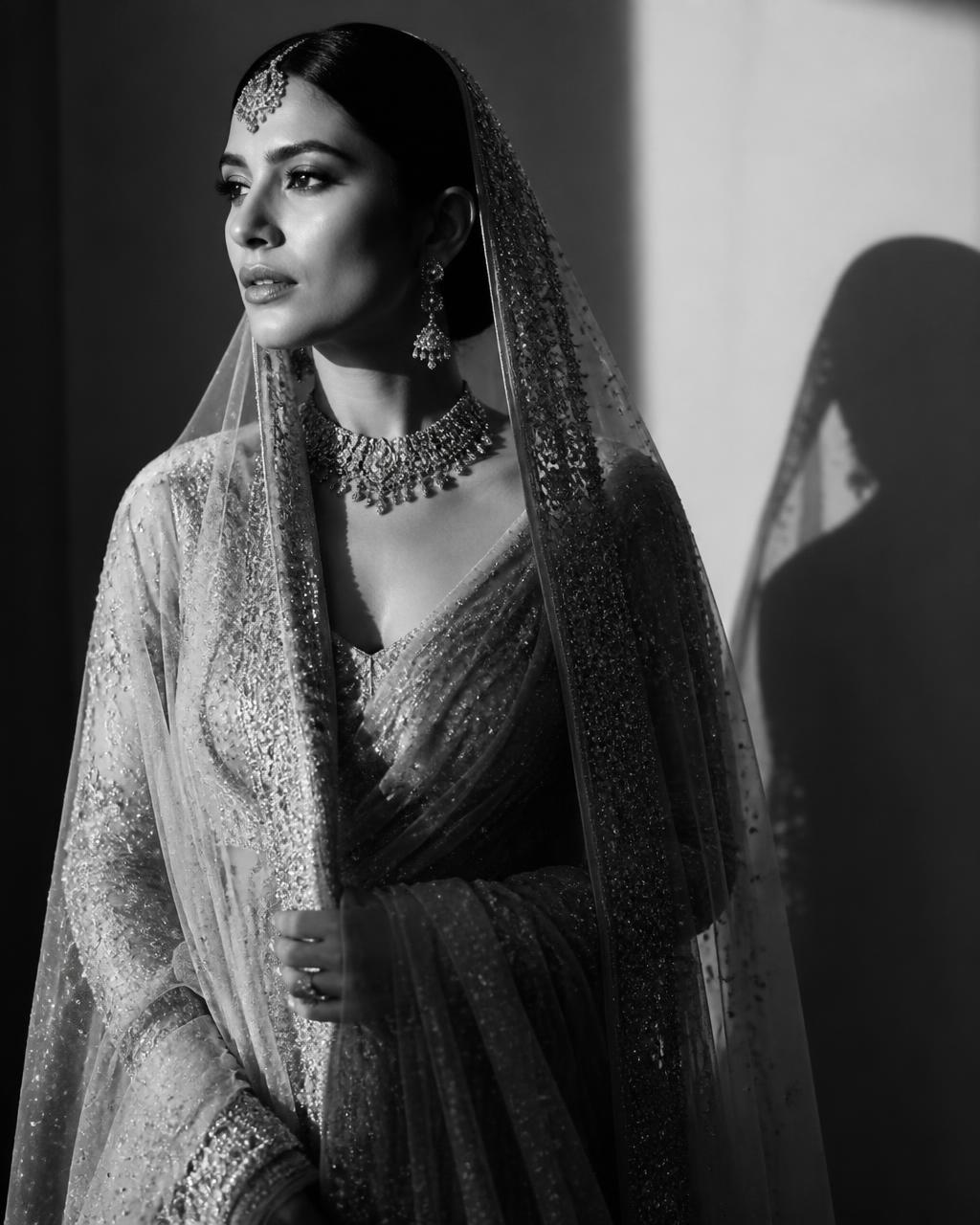Black and white editorial portrait of a celebrity bride in dramatic light